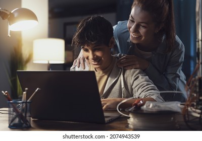 Teenagers Learning 3D Modeling And Using A 3D Printer, The Boy Is Using A Laptop And The Girl Is Helping Him