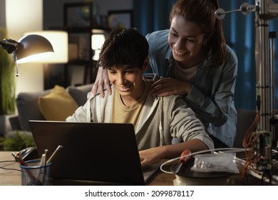 Teenagers Learning 3D Modeling And Using A 3D Printer, The Boy Is Using A Laptop And The Girl Is Helping Him