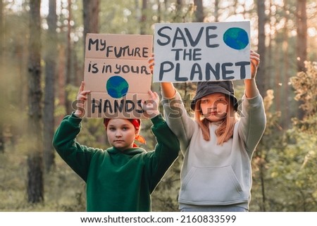 teenagers looking to camera with My Future in Your Hands poster support save planet  movement. youth volunteer protesting for safe ecology, global warming, pollution, plastic pollution.Earth World Day