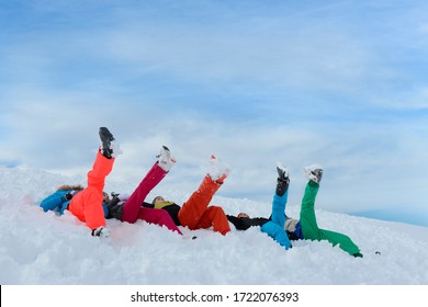 Teenagers lying on ski slope on skiing holiday, Tirol, Austria, Europe