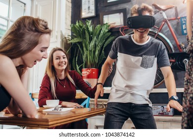 Teenagers Passing Leisure Time By Testing Virtual Reality Helmet Playing Funny Games At Home