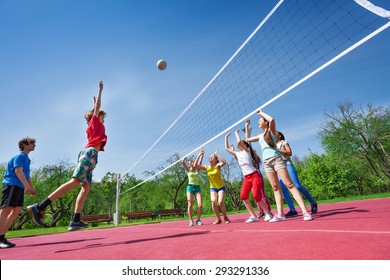 Teenagers Play Volleyball Game On Playing Ground