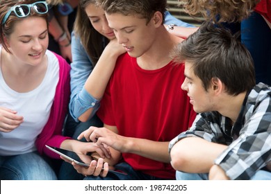 Teenagers Playing Games On A Tablet Computer