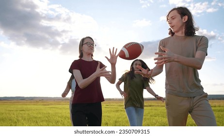 teenagers playing rugby in the park. group of teenagers play american football run outdoors in the park in summer. happy family kid dream concept. family teen play lifestyle american football run - Powered by Shutterstock