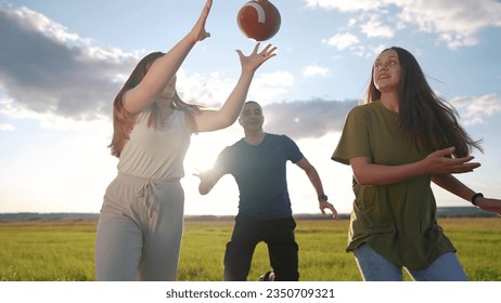 teenagers playing rugby in the park. group of teenagers play american football run outdoors in the park in summer. happy family kid dream concept. family teen play american football lifestyle run - Powered by Shutterstock