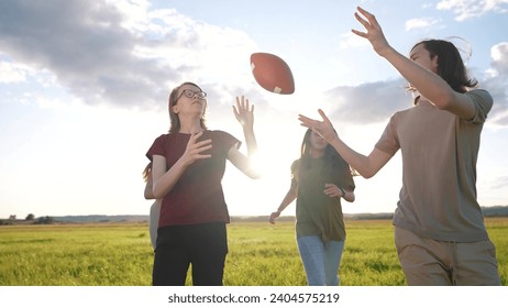 teenagers playing rugby in the park. group of teenagers play american football run outdoors in the park in summer. happy family kid dream concept. family teen lifestyle play american football run - Powered by Shutterstock