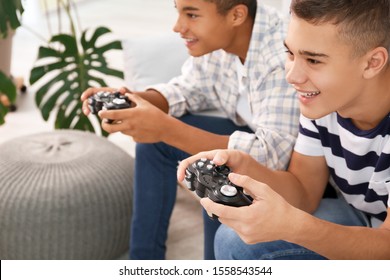 Teenagers Playing Video Games At Home