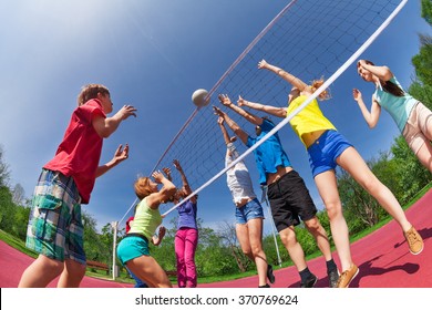 Teenagers Playing Volleyball On The Game Court