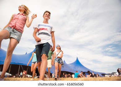 Teenagers At Summer Music Festival In Front Of Big Blue Tent