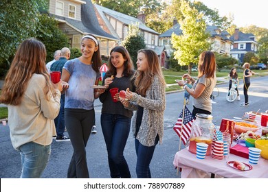 Teenagers Talking In The Street At A Block Party