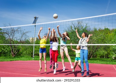 Teenagers team actively playing volleyball game