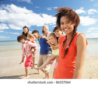 Teenagers Walking On Beach