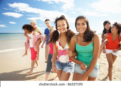 Teenagers Walking On Beach