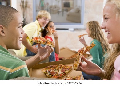 Teenagers Watching TV And Eating Pizza