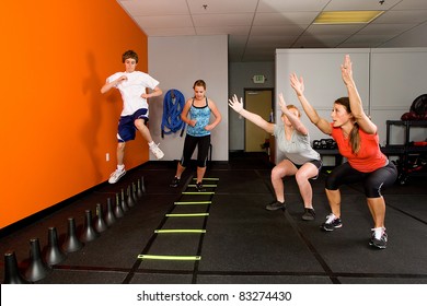 Teenagers working out together in a gym - Powered by Shutterstock