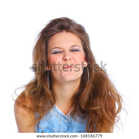 Teenagre girl grimacing. Face portrait against white background