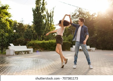 Teens Dancing In The City Park. Couple In Love. Romantic First Date. Carefree And Free Youth.