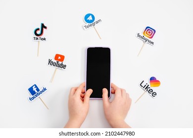 Teens Kids Social Media Addiction, Detox, Fomo. Logos Of Social Networks And Messengers Facebook, Instagram, YouTube, Telegram And Cell Phone In Teens Kids Hand. Kropivnitskiy, Ukraine, May 04, 2021