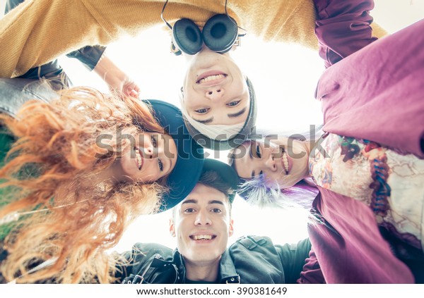 Teens portrait. group of teens hugging together and\
sharing good mood