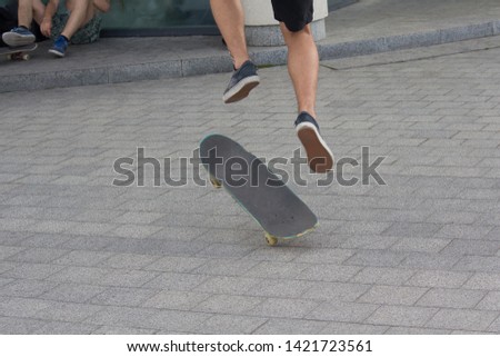 Teens ride a skateboard in the city. Youth culture
