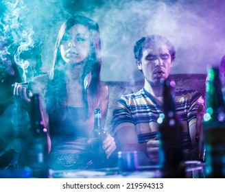 Teens Smoking Marijuana In Smoke Filled Room
