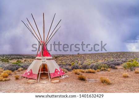 Teepee, Tipi or wigwom, a traditional cone-shape tent used by Indian in North america. Taken from reservation area in Grand Canyon West Rim, Arizona, USA. Heavily raining in the background.