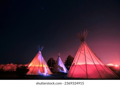 Teepee's glowing at night in Marfa, Texas - Powered by Shutterstock