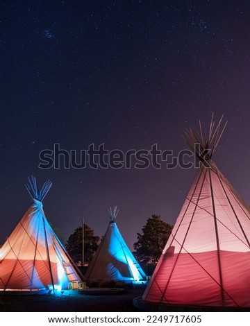Teepees glowing under a starry sky at night in Marfa, Texas Imagine de stoc © 