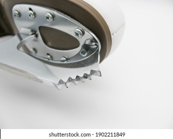 The Teeth Of The Blade Of A White Figure Skate Close-up On A White Background.