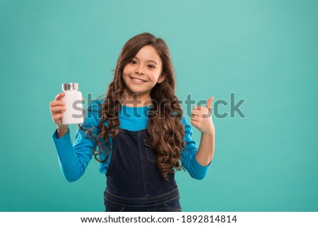 For teeth and bones. Daily amount of nutrients. Little cute child going to take vitamin. Food additives. Pills for kids. Vitamin and mineral complex. Medicine concept. Boost immunity. Best vitamins.