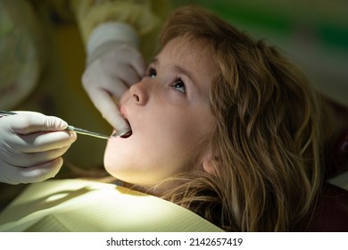 Teeth Checkup At Dentists, Examining Teeth Close Up. Dentist Examining Kids Teeth In The Dentists Chair. Treatment Teeth Children, Medical Checkup Oral Cavity With Instruments, Stomatology.