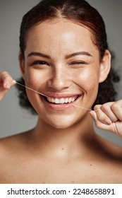 Teeth flossing, dental floss and portrait of woman with a smile in studio for oral hygiene, health and wellness. Face of happy female on grey for self care, healthcare and grooming for healthy mouth - Shutterstock ID 2248658891