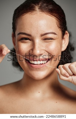 Teeth flossing, dental floss and portrait of woman with a smile in studio for oral hygiene, health and wellness. Face of happy female on grey for self care, healthcare and grooming for healthy mouth