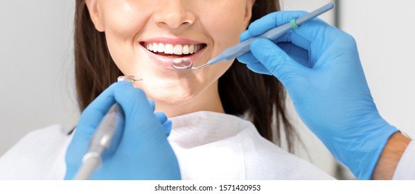 Teeth health concept. Cropped photo of smiling woman mouth under treatment at dental clinic, panorama - Powered by Shutterstock