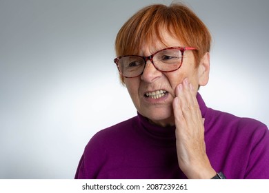 Teeth Problem. Mature Woman Feeling Tooth Pain. Dental Health And Care Concept. Toothache. Senior Woman Suffering From Tooth Pain And Touching Cheek. Dental Problem Concept.