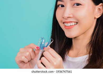 Teeth retaining tools after removable braces, Portrait young Asian beautiful woman smiling holding silicone orthodontic retainers for teeth, Orthodontics dental healthy care concept
