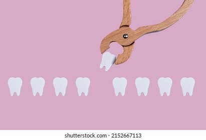 Teeth row and forceps for tooth extraction. Oral health problems and dentist work concept on pastel background. Children game at doctor. High quality photo - Shutterstock ID 2152667113