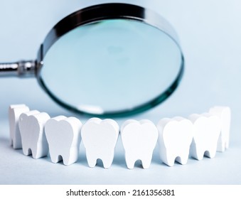 Teeth In Smile Form With Magnifying Glass. Dental Checkup, Tooth, Gums, Mouth Examination Concept. Routine Visit To Dentist And Checking For Cavity, Plaque, Periodontal Disease. High Quality Photo