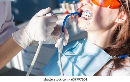 Teeth whitening procedure in the dental office - Powered by Shutterstock