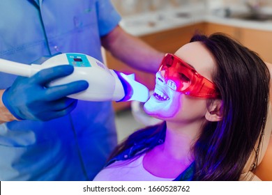 Teeth Whitening For Woman. Bleaching Of The Teeth At Dentist Clinic.