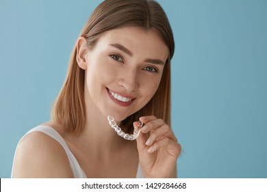 Teeth Whitening. Woman With White Smile, Healthy Straight Teeth Using Clear Removable Braces, Invisible Teeth Tray. Portrait Of Girl Doing Dental Beauty Treatment 