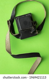 Tefillin made of black cowhide, on a green background
