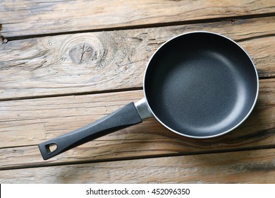 Teflon Frying Pan On A Wooden Floor.