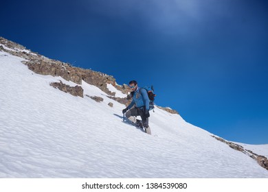 Tehran / Iran- 01192018: A climber walks across a filled snow mountain.
