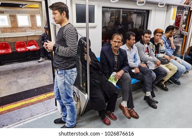 Tehran, Iran - April 29, 2017: Several men and one woman are sitting in the passenger cabin of the subway train car. - Shutterstock ID 1026876616