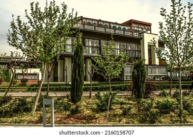 Tehran, Iran, March 02, 2022: A new cafe among young trees and flowering bushes on the shore of the artificial lake "Chitgar Lake" in the new residential area "Bam Land" of the city of Tehran