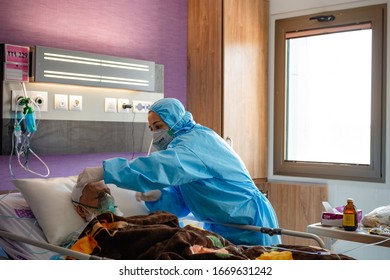 Tehran, Iran, March 2020: A Nurse Is Taking Care Of An Old Man With Coronavirus Disease.