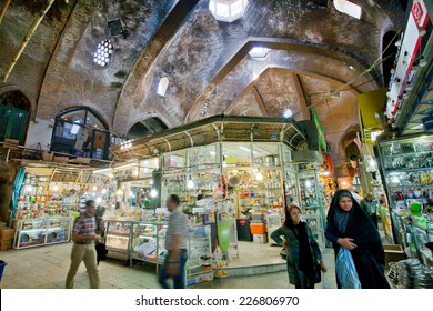 TEHRAN, IRAN - OCTOBER 6: Motion blurs of rushing women and men inside the old bazaar on October 6, 2014. About 30% of Iran's public-sector workforce and 45% of industrial firms are located in Tehran
