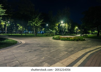 The teiled road in the night park with lanterns in autumn. Benches in the park during the autumn season at night. Illumination of a park road with lanterns at night. Park Kyoto - Powered by Shutterstock