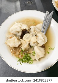 Tekwan is a typical Palembang food meatballs made from a mixture of fish meat and tapioca served with vermicelli, sliced jicama, mushrooms, sprinkled spring onions, celery and fried shallots.